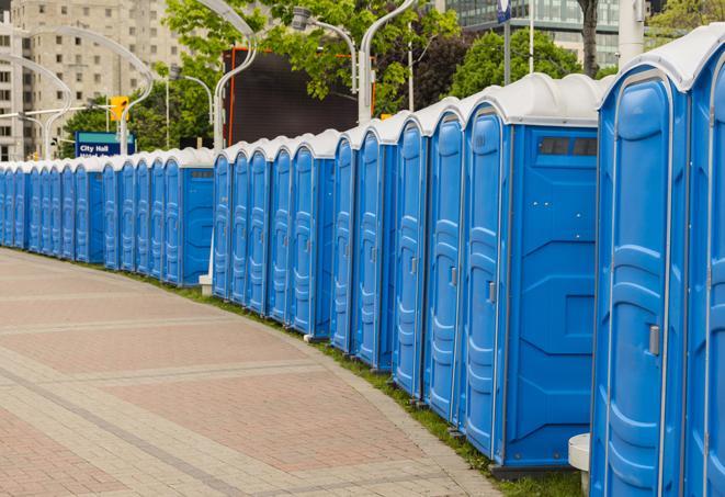 a line of portable restrooms at a sporting event, providing athletes and spectators with clean and accessible facilities in Emmett